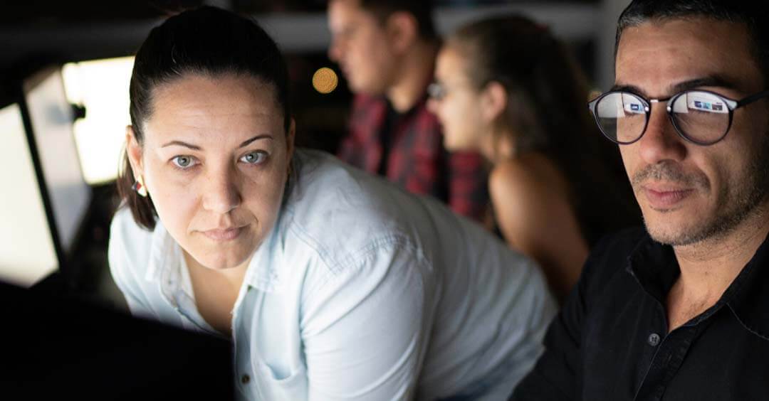 A woman and man looking at a screen